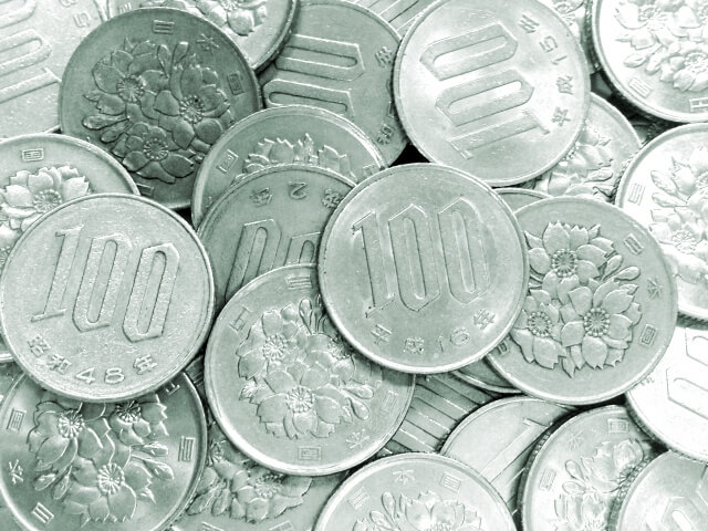 A pile of Japanese 100 yen coins featuring cherry blossom designs.