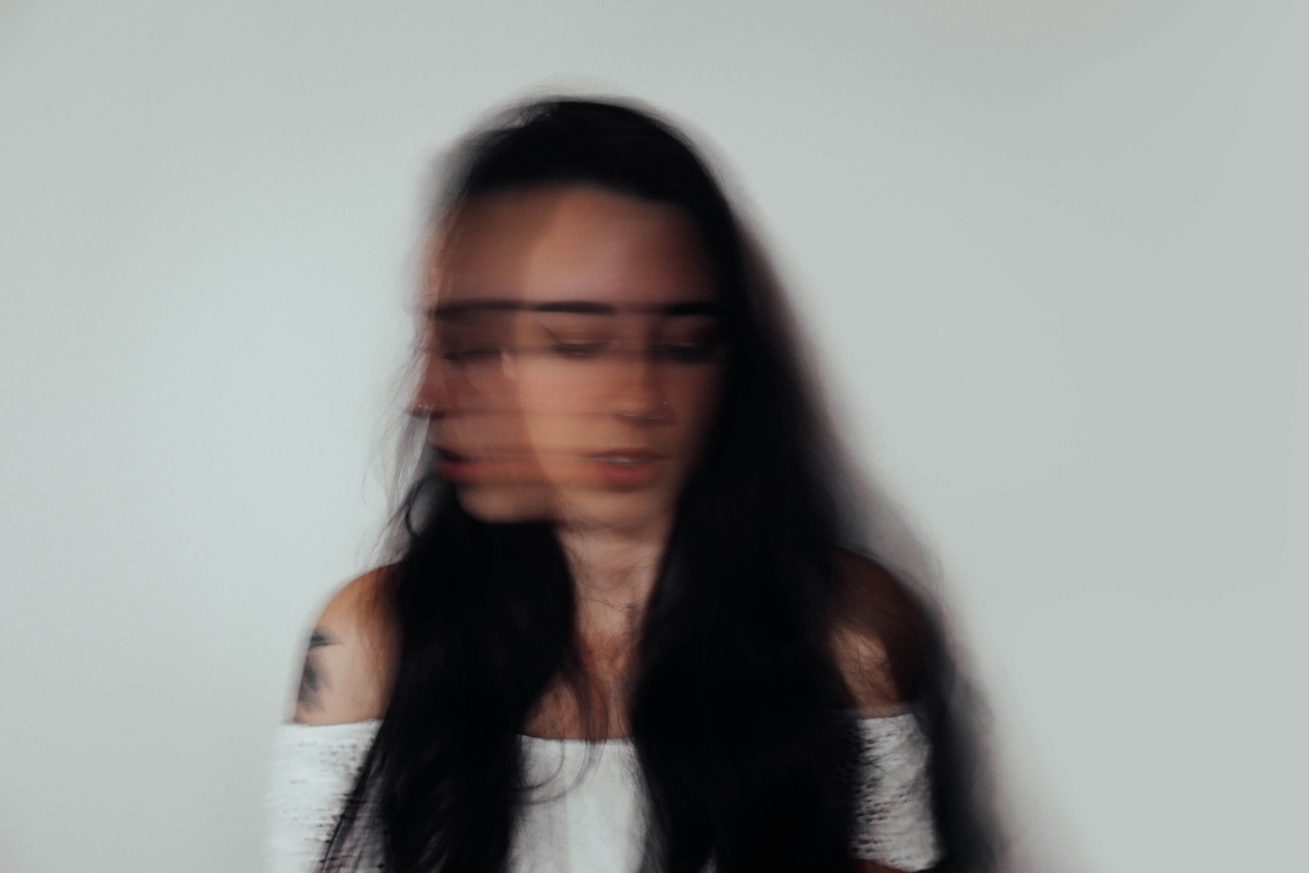 Blurred image of a woman representing negation.
