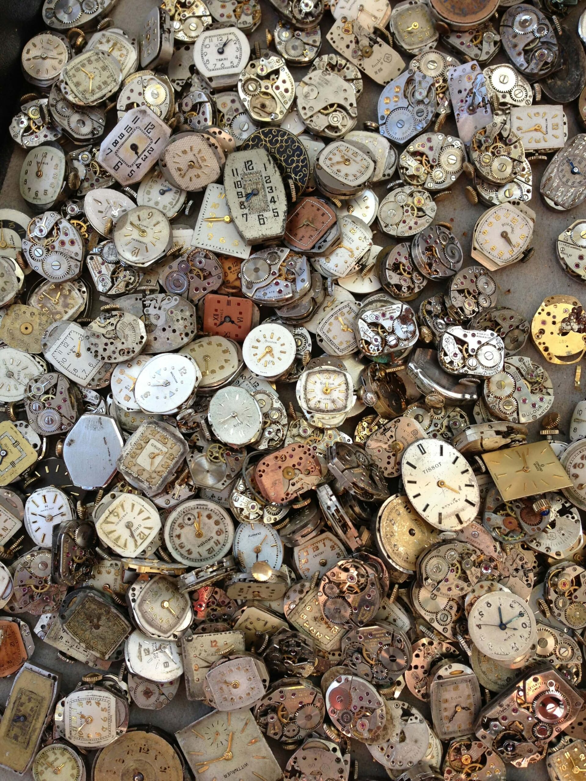  A collection of old watch faces and mechanisms, symbolizing the past. This image represents the concept of the past tense of "desu" in Japanese grammar.
